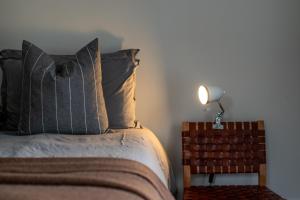 a bedroom with a bed and a lamp on a night stand at European Style House in Hobart +17 photos