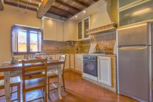 a kitchen with a refrigerator and a stove top oven at APPARTAMENTO SULLA SALA in Pistoia