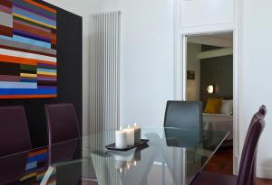 a dining room with a glass table and a painting at Elegant Apartment at Chiaia by Wonderful Italy in Naples