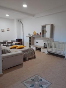 a bedroom with a bed and a crib in it at Casa Vacanze Sunshine in Scanzano