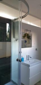 a bathroom with a sink and a glass shower at Zaciszny domek in Słupsk +85 photos