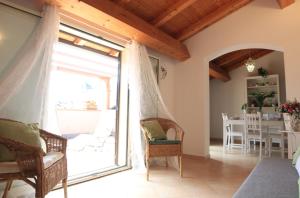 a living room with a large sliding glass door at Le Terrazze dell'Etna Appartmento in villa in Ragalna