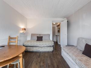 a room with a bed and a table and a couch at Studio Courchevel 1650, 1 pièce, 3 personnes - FR-1-563-62 in Courchevel