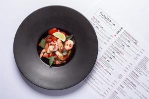 a bowl of food on a table next to a receipt at Aparthotel Apartamenty Czarna Góra 112 in Sienna