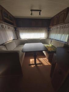 a living room with a couch and a table at Kemping Pod Topolami in Górkło +30 photos