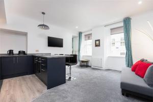 a living room with a desk and a couch at City centre 2 bedroom flat with on site parking in Perth