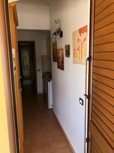 um corredor que leva a uma cozinha com frigorífico em Residence Il Melograno em Lampedusa