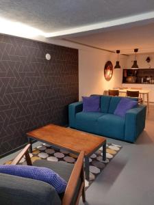 a living room with a blue couch and a table at Simplon Hostel in Groningen