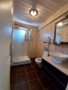 ein Bad mit einer Dusche, einem WC und einem Waschbecken in der Unterkunft KILIÇ MOTEL in Istanbul