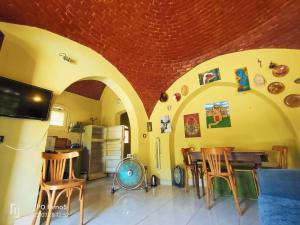 a room with a kitchen with a table and chairs at Touha House in Fayoum