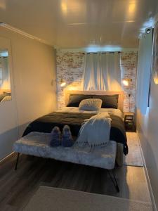 ein Schlafzimmer mit einem Bett mit zwei Schuhen drauf in der Unterkunft Anahita Studio in Balingup