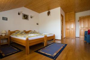a bedroom with a bed and a wooden floor at Villa Jäger in Vonyarcvashegy