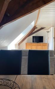 two blue chairs in a room with an attic at Landhaus Lindenbusch in Weseke