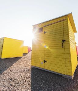 two large yellow garage doors on a building at Kirjurin Leirintä in Pori