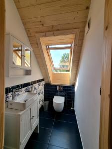 a bathroom with a sink and a window at Babiogórska Chata - dom z bali z jacuzzi i sauną in Zawoja