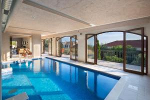 a swimming pool with a view of a house at Villa Gradina in Budva