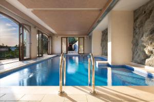 a swimming pool in a house with glass doors at Villa Gradina in Budva +53 photos