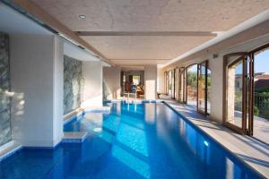 a swimming pool with blue water in a building at Villa Gradina in Budva