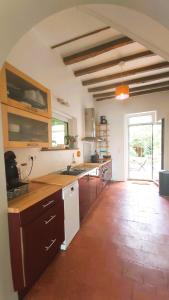 a large kitchen with a counter and a large window at La Maison de Louise Chinon #chateaux #vignobles in Chinon