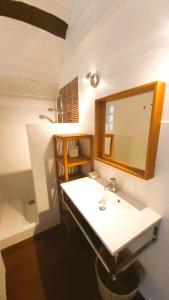 a bathroom with a sink and a mirror at La Maison de Louise Chinon #chateaux #vignobles in Chinon