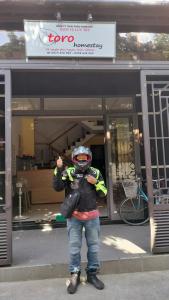 a person standing in front of a store at Toro Homestay in Hoi An