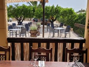 a balcony with tables and chairs on a patio at ZINC in Mutxamel
