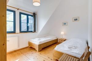 a bedroom with two beds and a window at 3-Raum Apartment bis 6 Pers 42 in Rankwitz