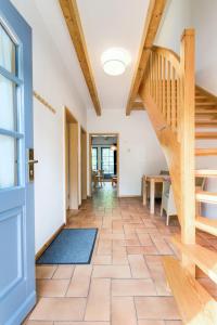 a hallway with a wooden staircase and a door at 4-Raum Apartment bis 6 Pers 21 in Rankwitz