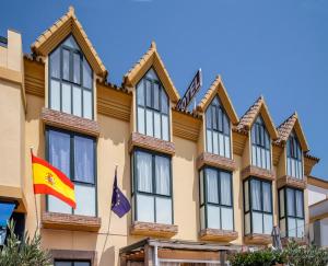 a building with flags in front of it at Hotel Doña Matilde in Estepona