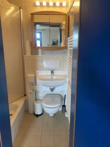 a small bathroom with a sink and a toilet at Studio 52 in Rankwitz