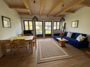 a living room with a blue couch and a table at 4-Raum Apartment bis 8 Pers 41 in Rankwitz