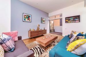 a living room with a couch and a table at Interior-Designer Apartment with 2 TERRACES in London