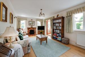 a living room with a couch and a table at Oak Tree Cottage, Charming, Rural New Forest Home in Boldre