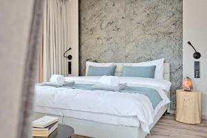 a bedroom with a large bed with towels on it at Harda House Friends & Spa in Zakopane