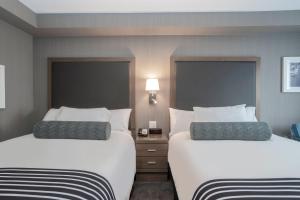 A bed or beds in a room at Sandman Signature St. John's Hotel