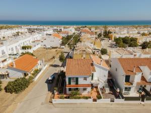 an aerial view of a town with houses and the ocean at Casa da Lota in Manta Rota