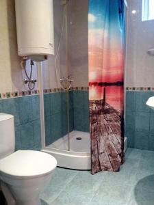 a bathroom with a shower with a toilet and a sink at Семеен хотел Бостън in Ravda