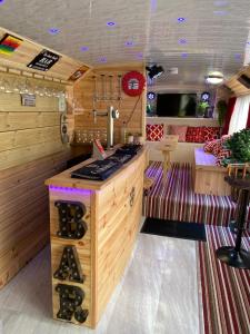 a bar in a kitchen with wooden walls at Double Decker Bus in Aberystwyth