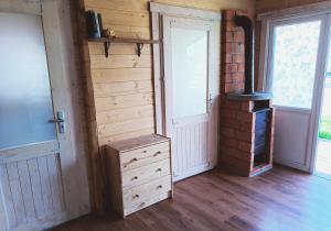 a room with a woodburning stove next to a door at Agroturystyka Jeleń in Jeleń
