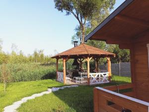 a gazebo with a table and chairs in a yard at Agroturystyka Jeleń in Jeleń