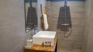 a bathroom with a white sink and a shower at O Petit Club Africain Dakar in Dakar
