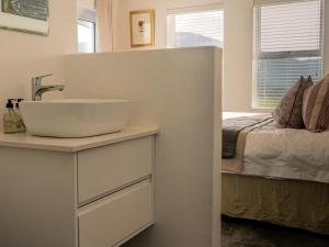 uma casa de banho com um lavatório e uma cama em Stanford View em Stanford