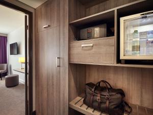 a bag sitting on a shelf in a room at Mercure Versailles Paris Ouest in Le Chesnay