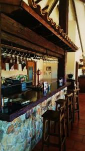 a bar in a restaurant with chairs and a counter at Las Mairas in Fuente Encalada