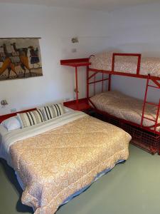 a bedroom with two bunk beds and a painting on the wall at Malevo Murana Hostel in Buenos Aires