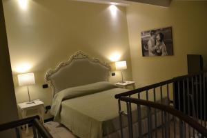 a bedroom with a bed and two lamps and a staircase at Art & Jazz Hotel in Catania