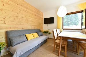 a living room with a couch and a table at Mate i Jaga in Saborsko