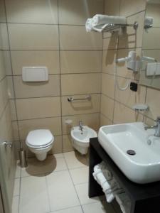 a bathroom with a toilet and a sink at Art & Jazz Hotel in Catania