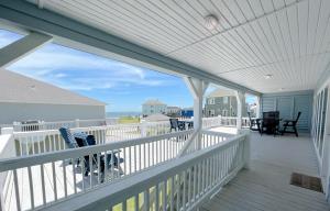 a balcony with chairs and a view of the ocean at Ohana home in Crystal Beach