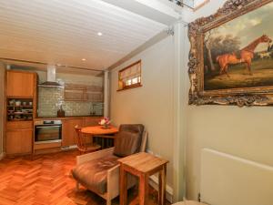 a kitchen with a painting of a horse on the wall at The Studio in Hungerford